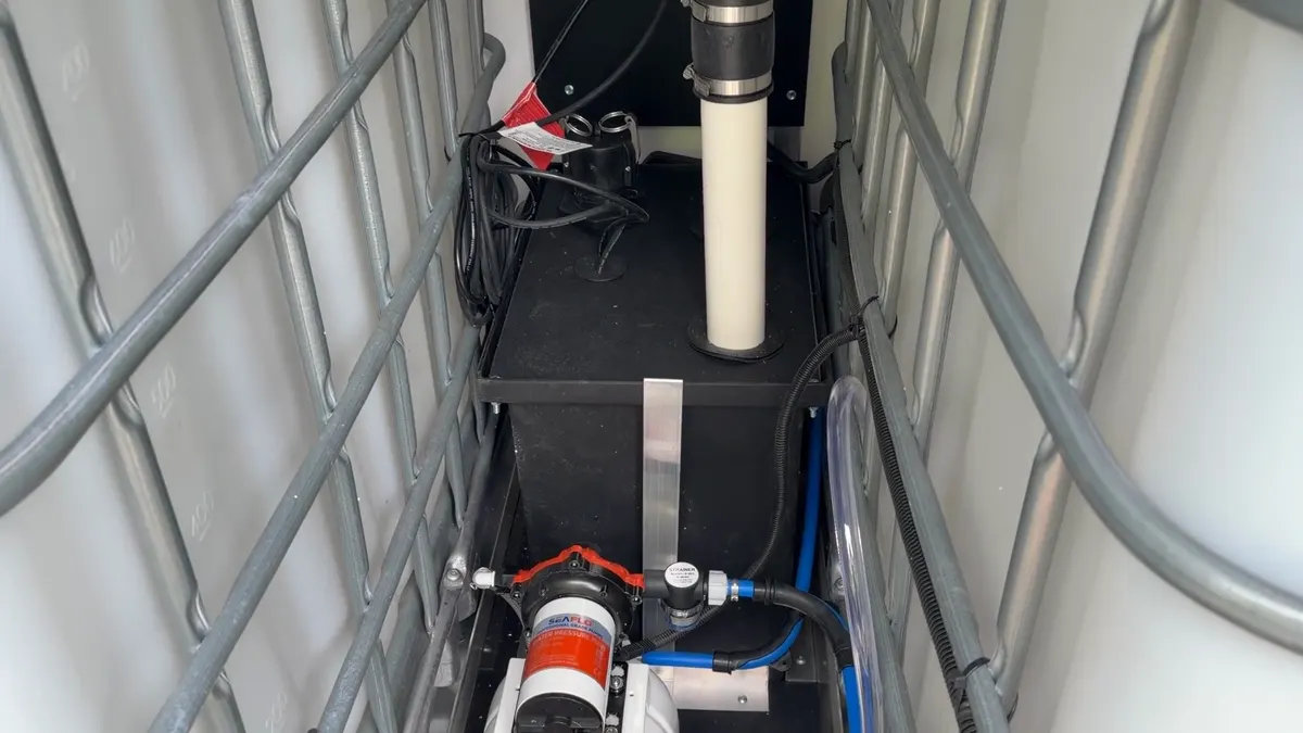 Sump basin with sewage pump and vent pipe inside the box