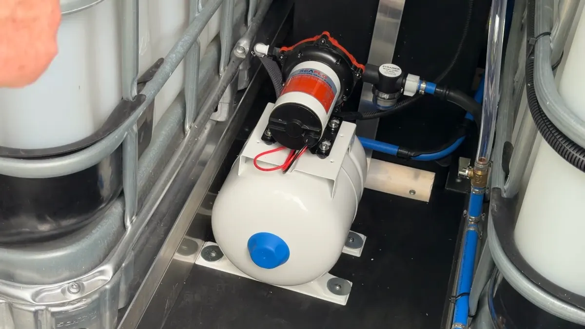 12V water pump mounted on a pressure tank inside the box